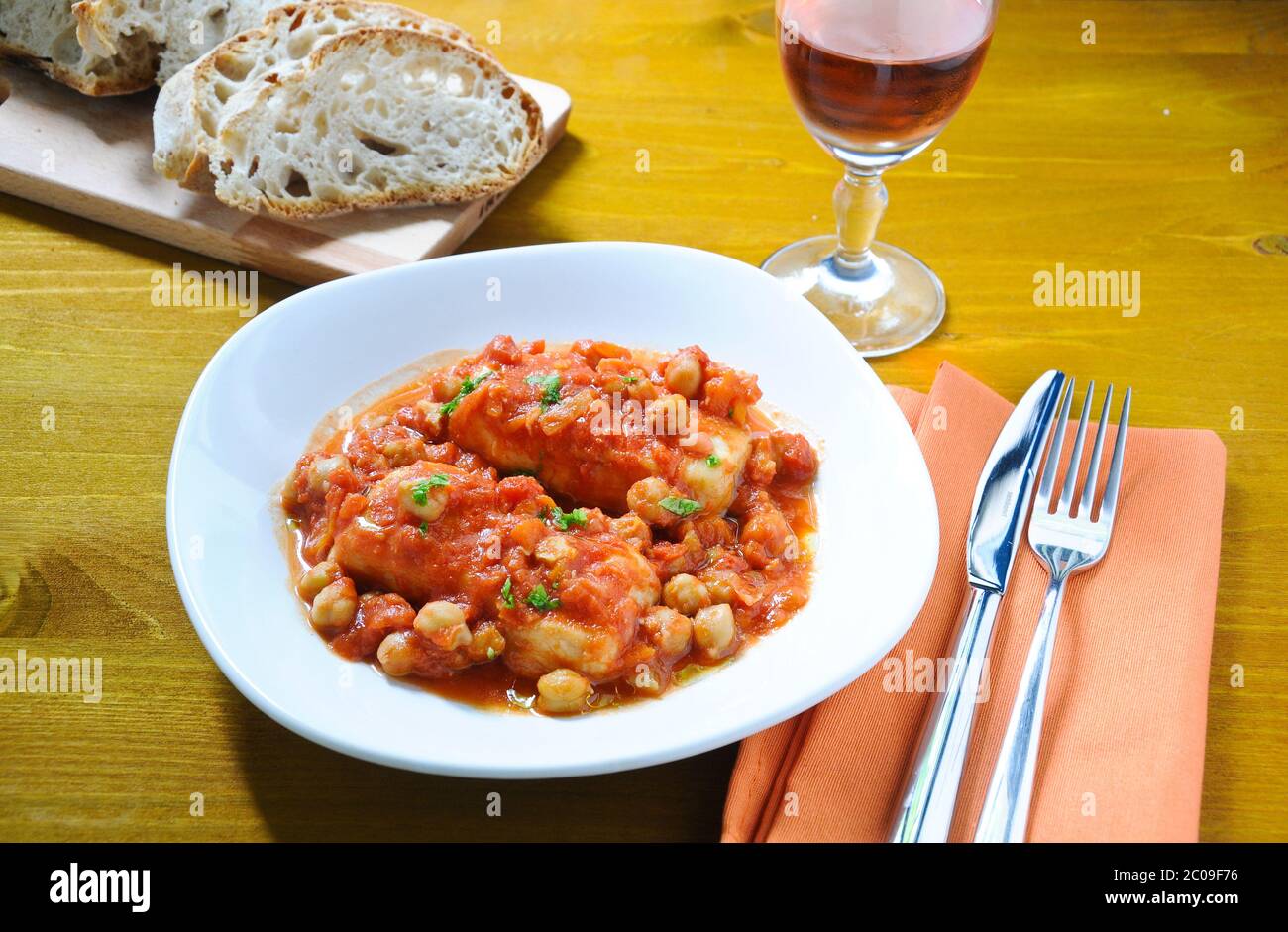 Salt cod with chickpeas and tomatoes Roman Stock Photo