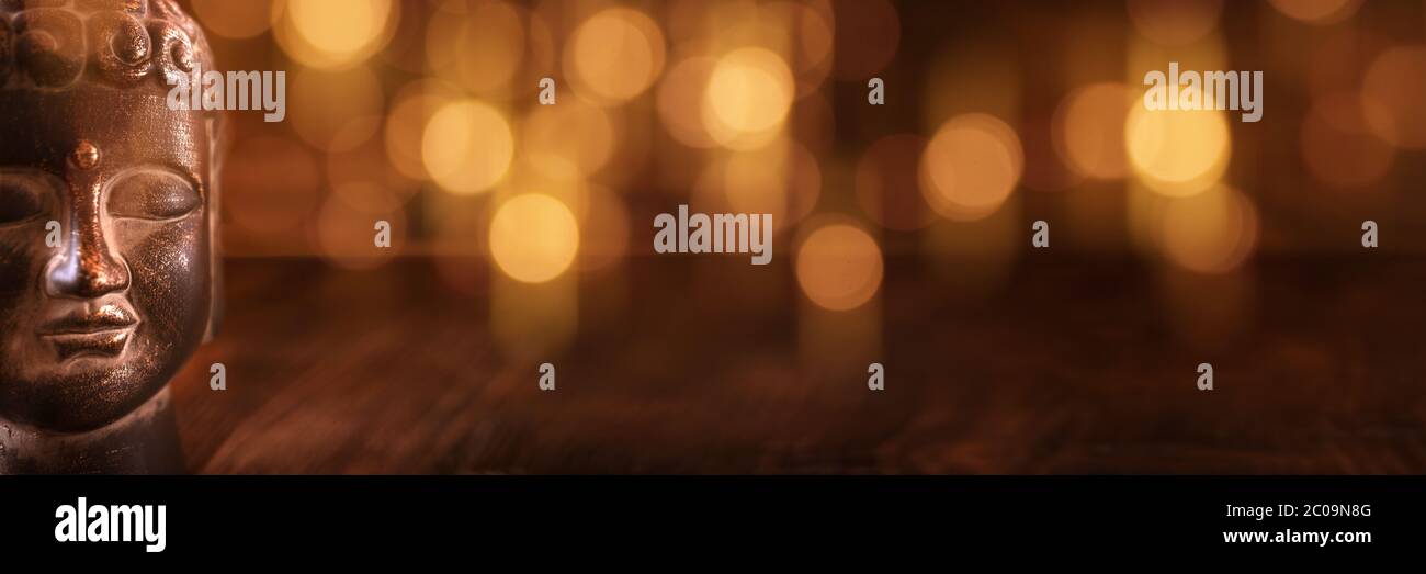 Buddha head on golden bokeh background for spiritual Stock Photo - Alamy