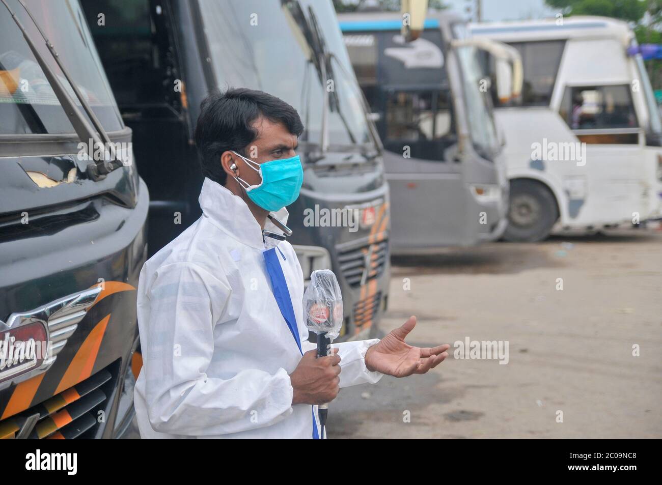 Bangladeshi News TV Channel reporter, covering his news with protection kit in the street of Sylhet, Bangladesh amid the Covid-19 pandemic Stock Photo