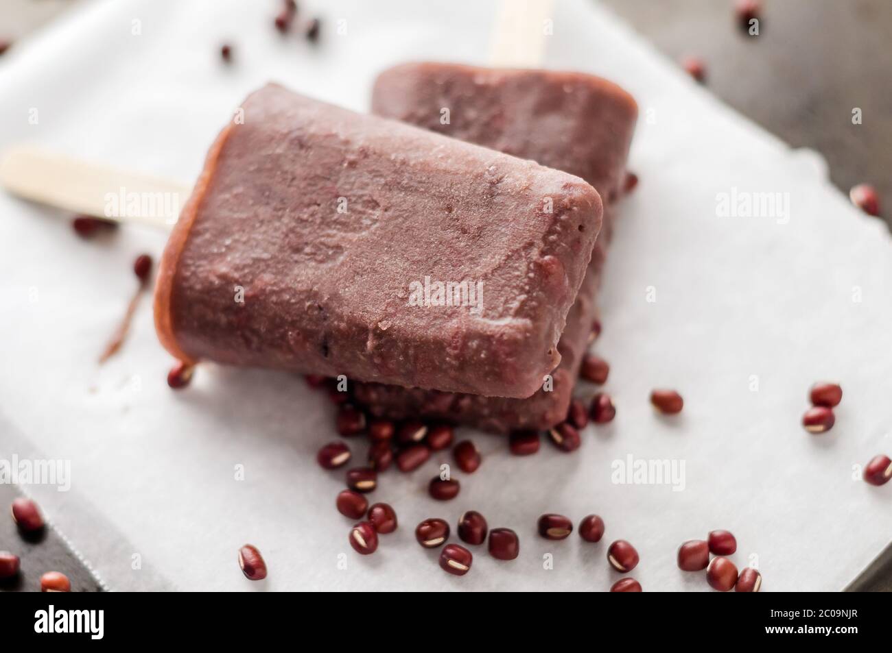 Frozen adzuki beans popsicle. Ice pops are a delicious way to cool off in hot summer days, these are made of red adzuki beans ice cream, a tiny Asian Stock Photo