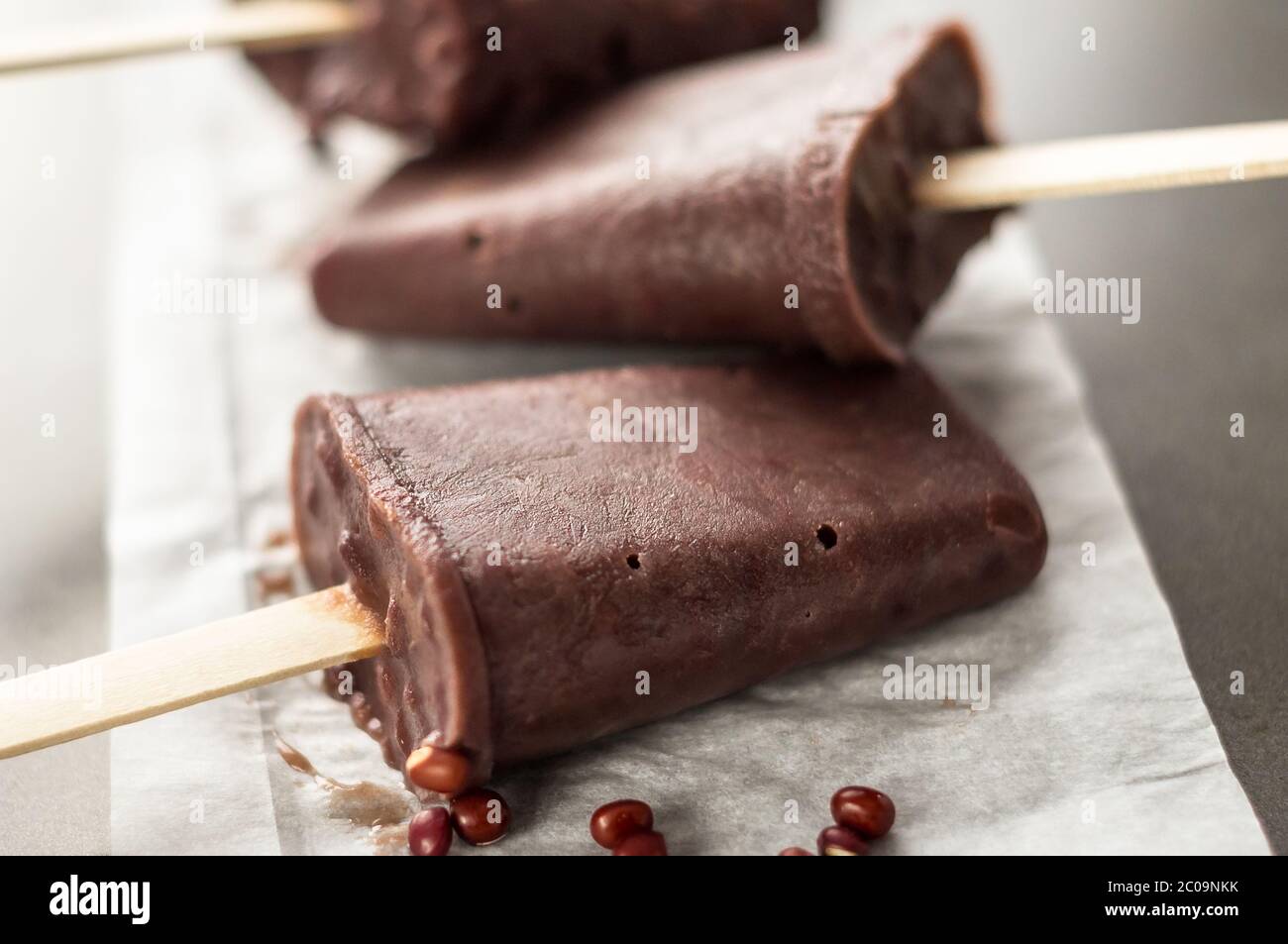 Sweet red bean popsicle closeup. Ice pops are a delicious way to cool off in hot summer days, these are made of red adzuki beans ice cream, a tiny Asi Stock Photo