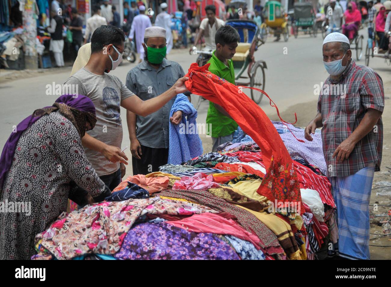 23 May 2020: Shoppers are gathered at the temporary street shop of Sylhet, Bangladesh. The lockdown is slowly easing and more people  getting out for Stock Photo