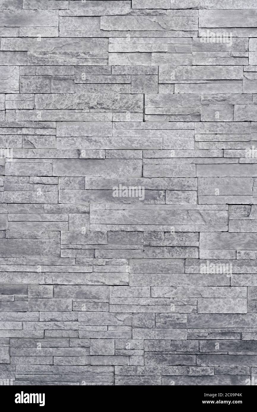 Stone veneer tiles stacked flat make beautiful & modern accent walls in interior design. Use this gray texture as wallpaper, background, backdrop... Stock Photo