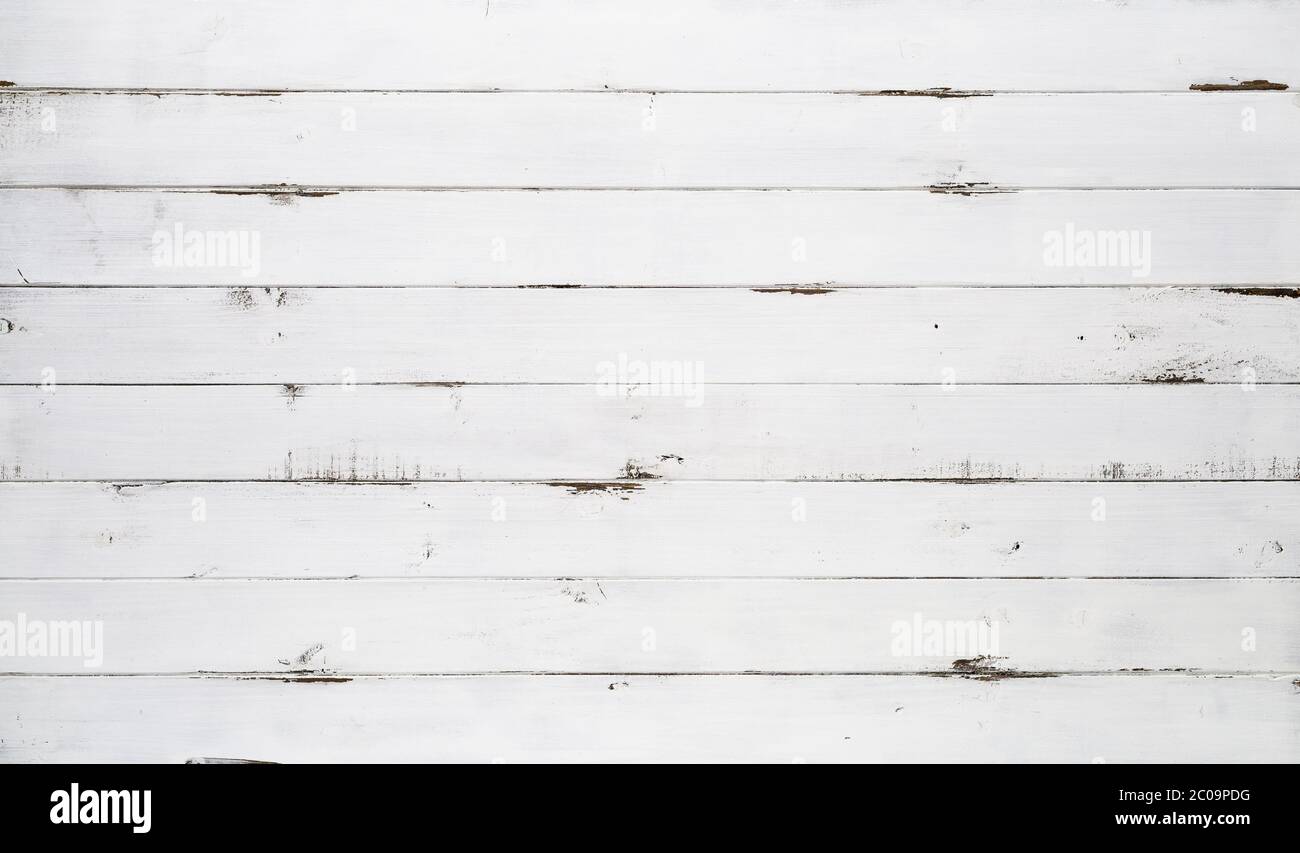 Distressed white wood texture background viewed from above. The wooden planks are stacked horizontally and have a worn look. This surface would be gre Stock Photo