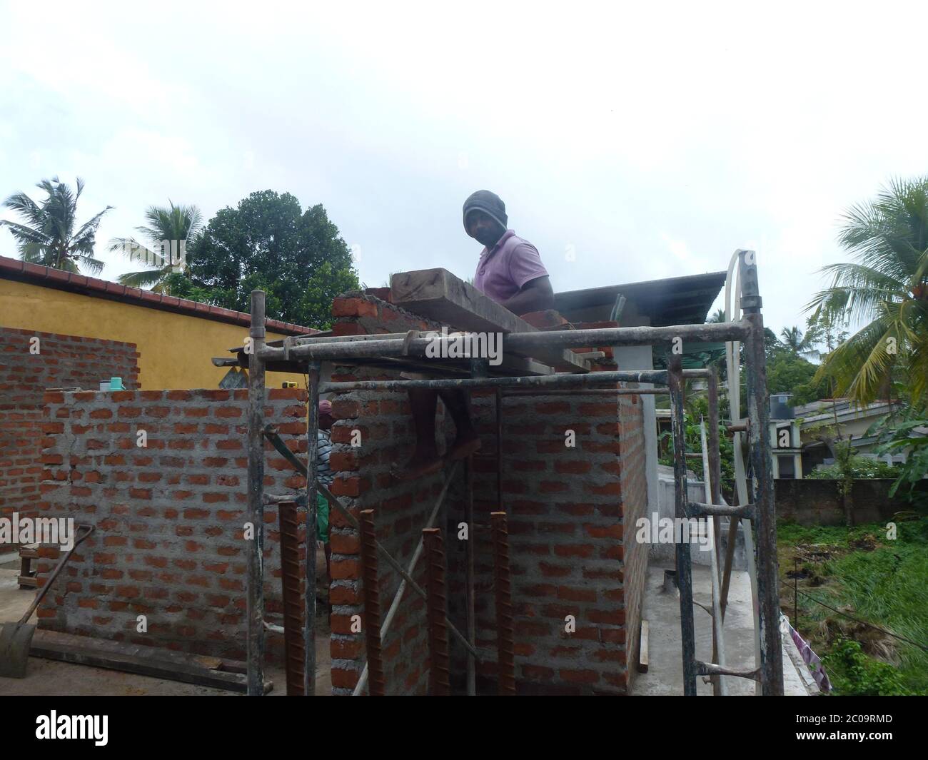 Men working on a construction site, building walls from Bricks. Colombo