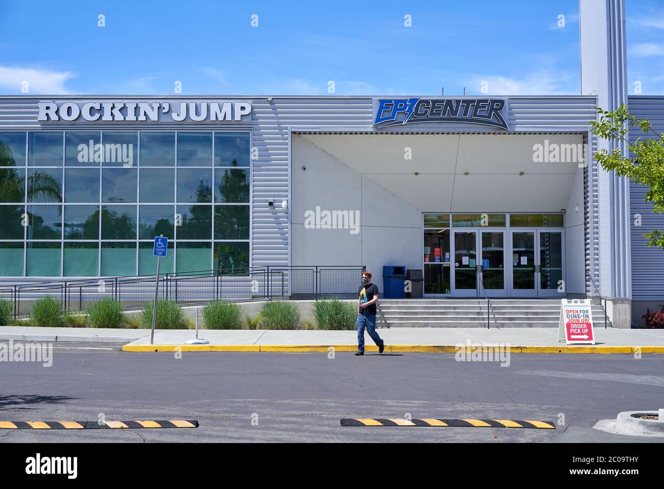 Man walks on parking lot at Epicenter sports and entertainment multi-business complex in Santa Rosa, California, USA. Stock Photo