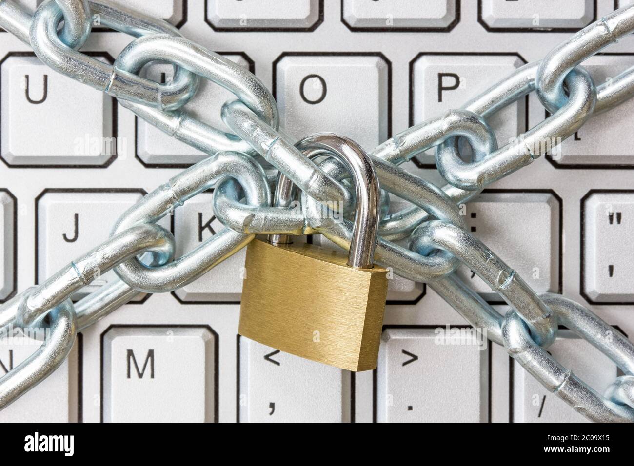 Locked chain on computer keyboard Stock Photo Alamy