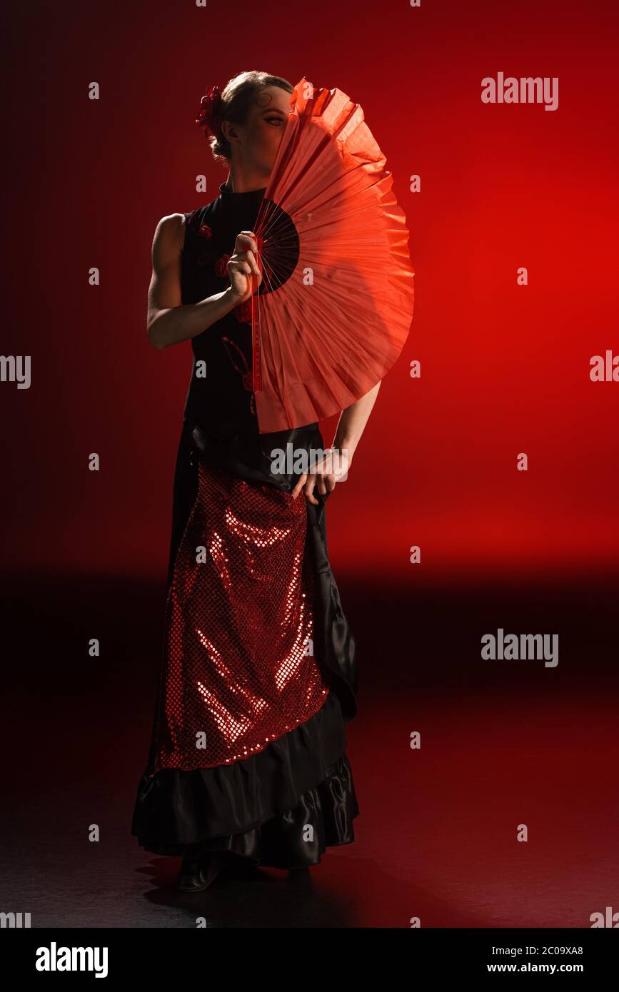 sachin and babi light blue dress Flamenco dancer in elegant red dress and fan strikes captivating pose  highlighting rhythmic essence main image 1