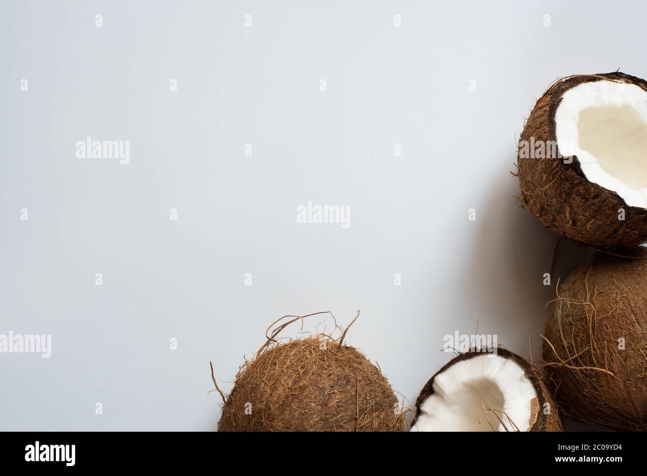 top view of fresh tasty whole coconuts and halves on white background ...