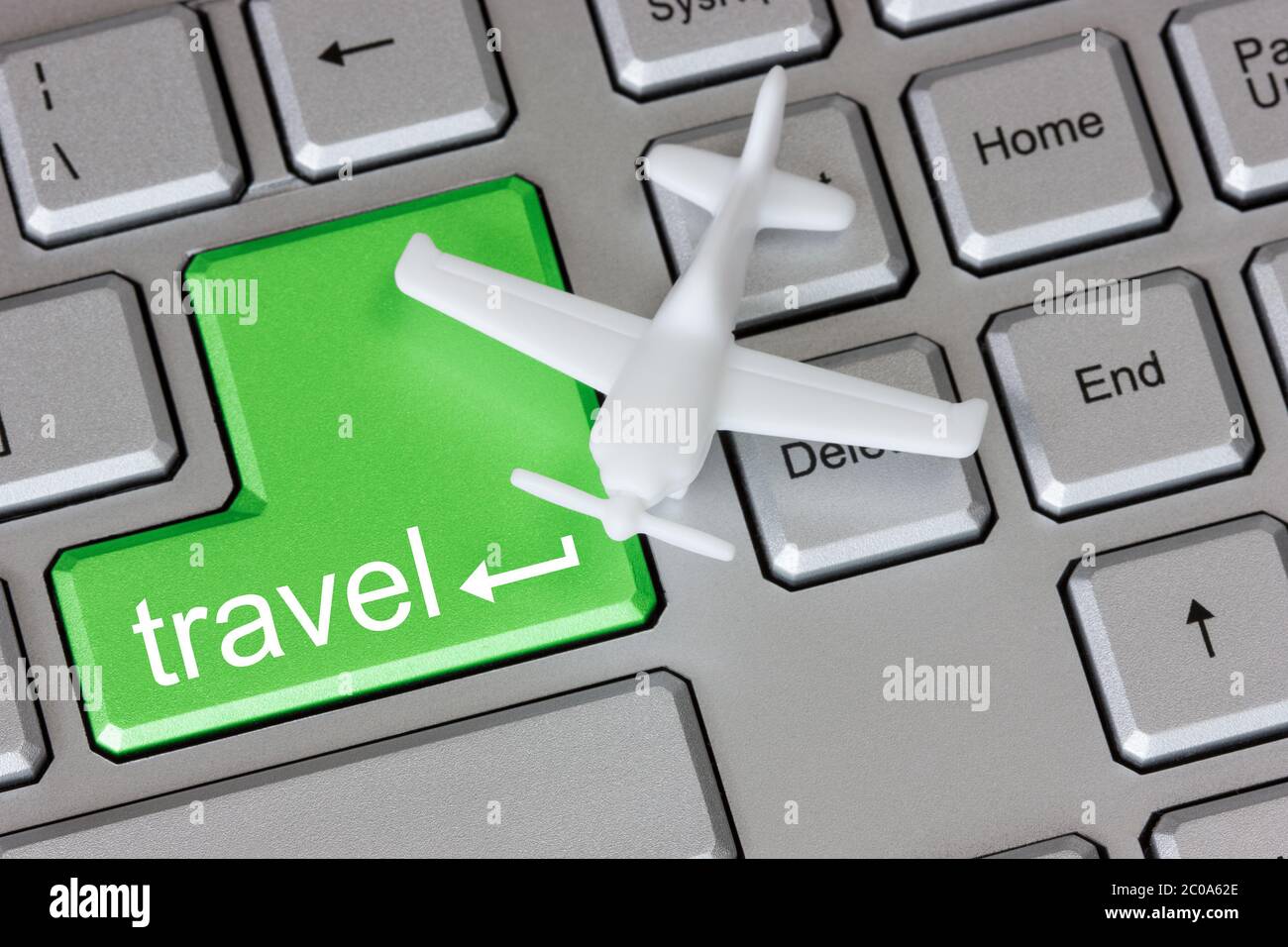 Plane on keyboard with travel button Stock Photo Alamy