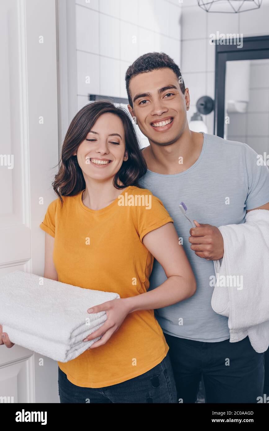 Happy Multiracial Couple Holding Towels In Bathroom Stock Photo Alamy happy-multiracial-couple-holding-towels-in-bathroom-stock-photo-alamy
