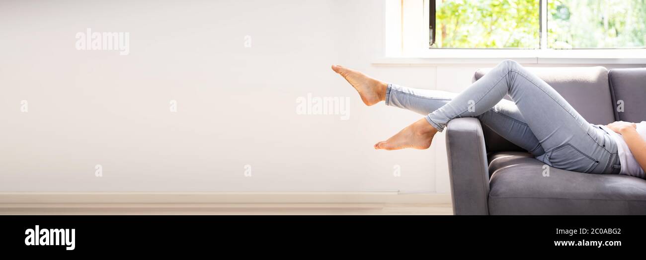 Lazy Woman Sleeping On Couch Or Sofa Stock Photo
