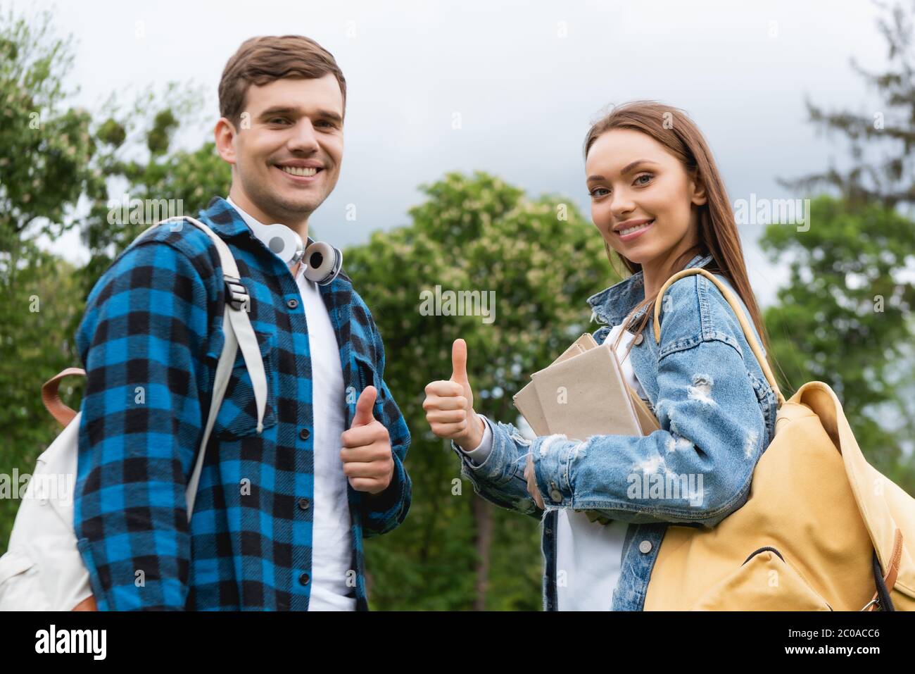 cheerful students looking at camera and showing thumbs up Stock Photo ...