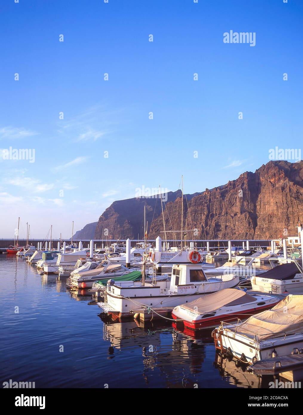 Fishing boats in harbour at sunrise, Los Gigantes, Tenerife, Canary Islands, Kingdom of Spain Stock Photo