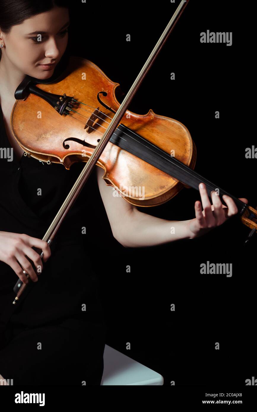 attractive female musician playing on violin on dark stage Stock Photo ...