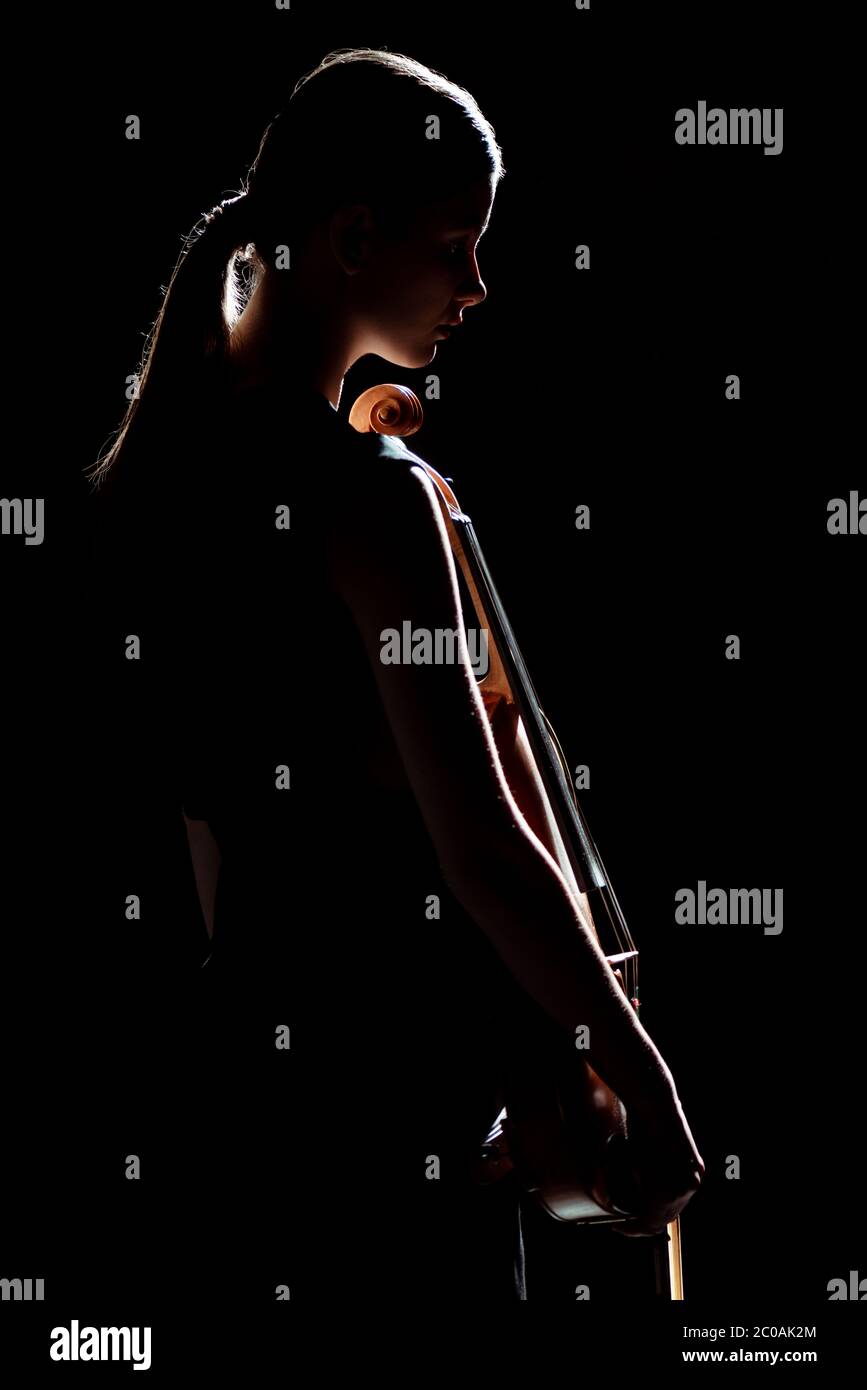 silhouette of female musician holding violin isolated on black Stock ...