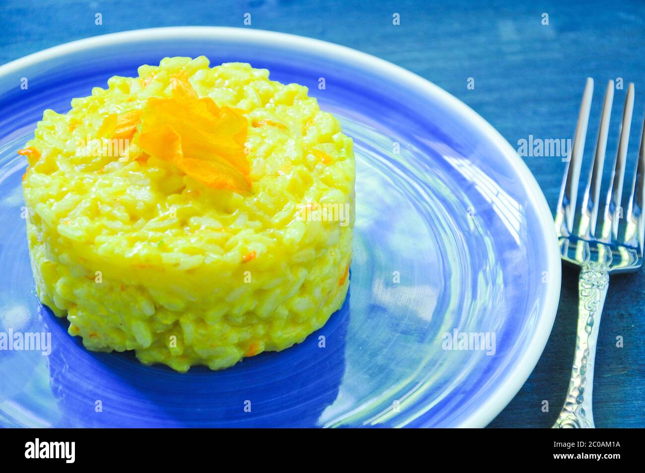 Risotto with pumpkin flowers with saffron cream Stock Photo