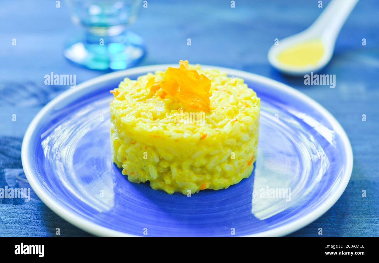 Risotto with pumpkin flowers with saffron cream Stock Photo