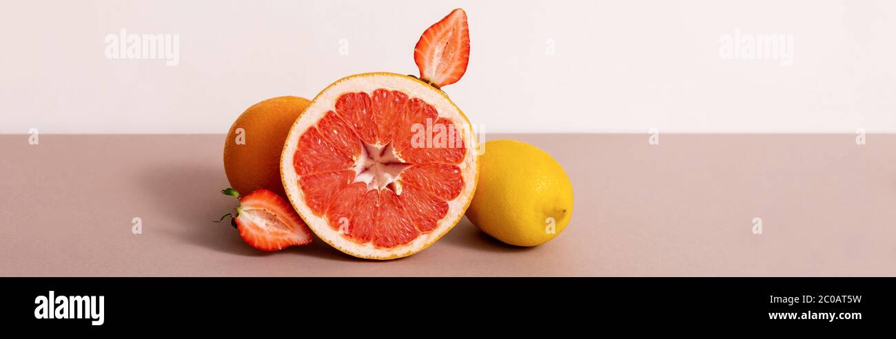 fruit composition with citrus fruits and strawberry isolated on beige, panoramic crop Stock Photo