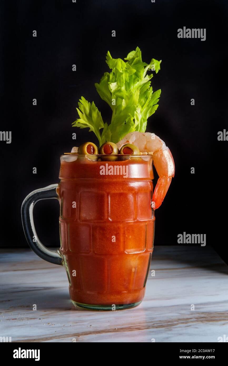 Bloody Mary vodka cocktail in a beer stein with shrimp garnish on