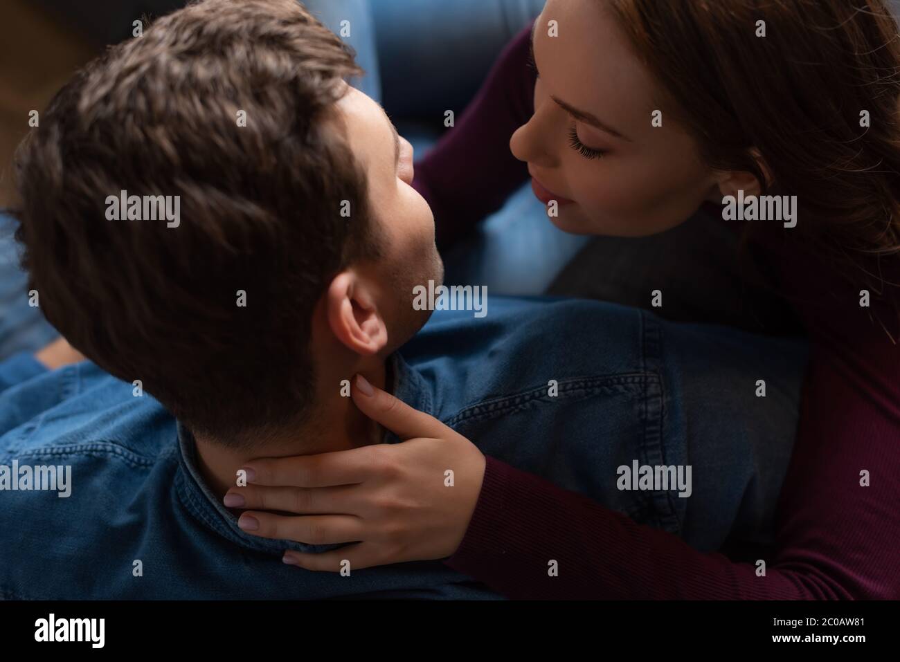 top view of girl touching neck of man in living room Stock Photo - Alamy