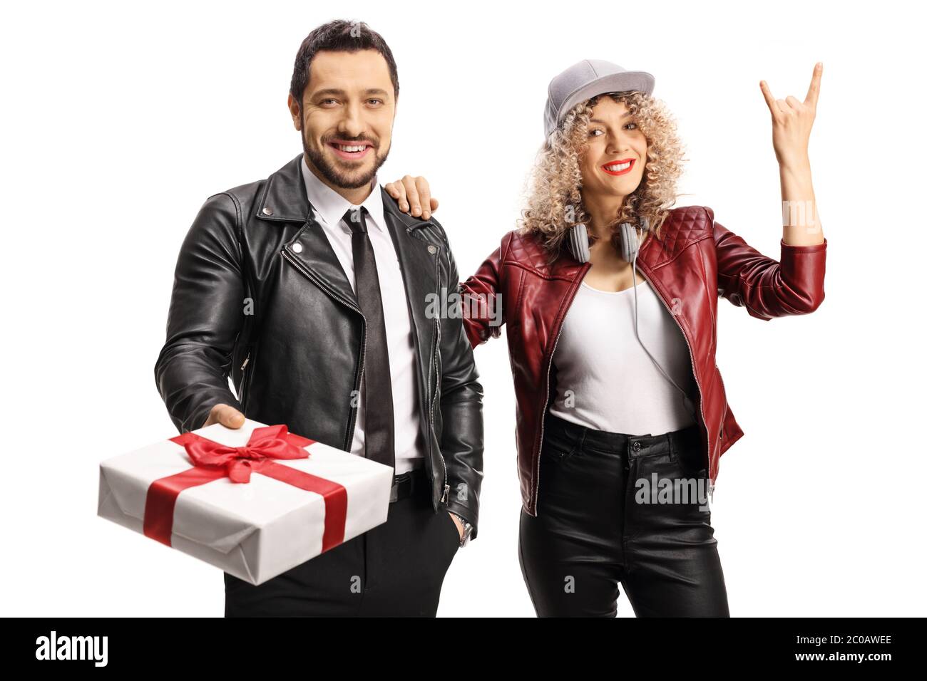 Cool young man and woman in leather jackets posing with a gift box