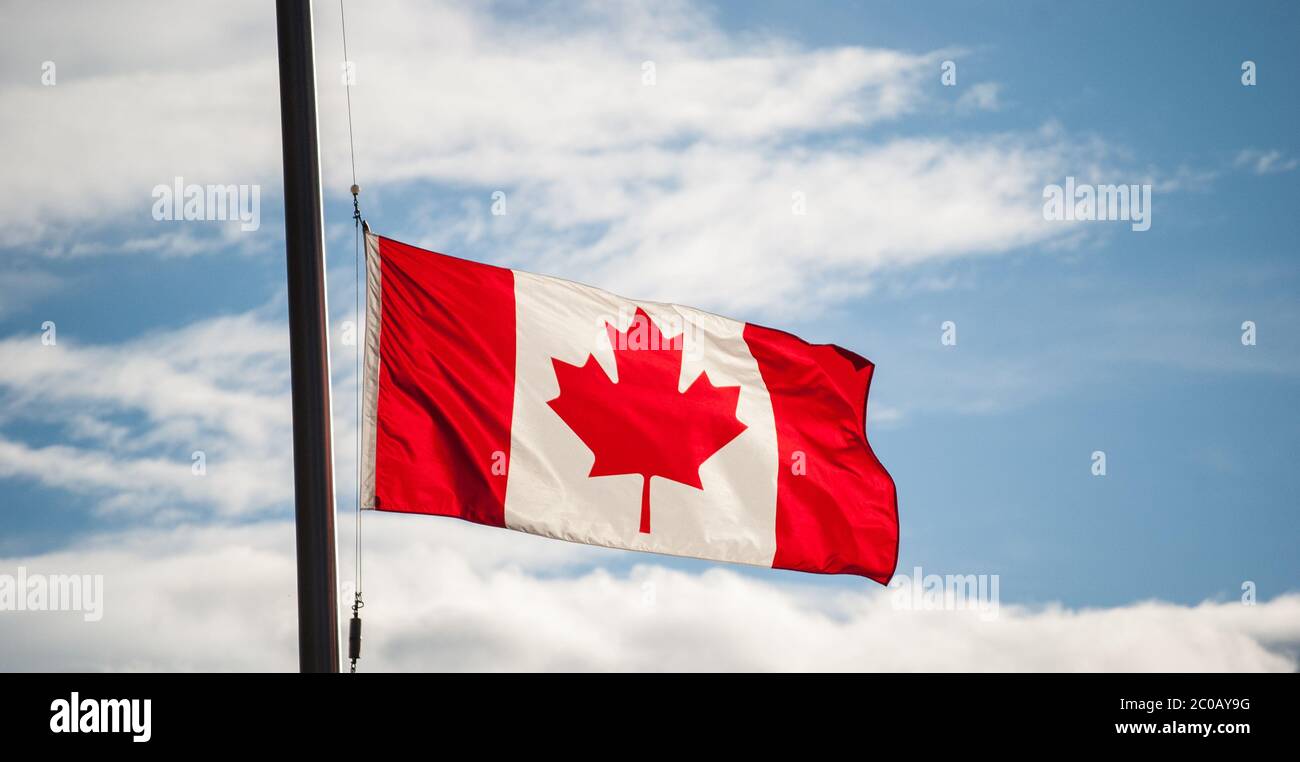 Canadian Flag Waving At Half-mast Stock Photo