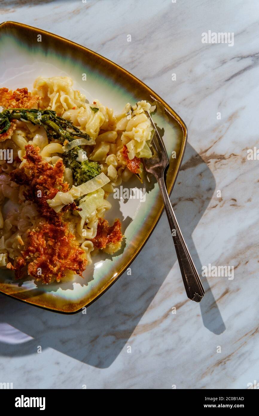 Broccoli rabe and leek mac and cheese with harsh sunlight Stock Photo