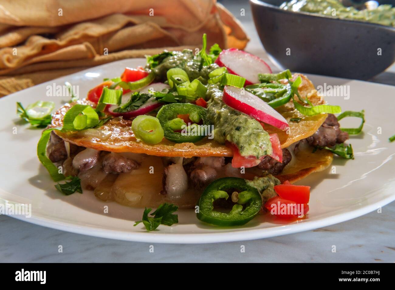 Mexican sirloin tip steak carne asada mulitas quesadillas with creme fraiche poblano pepper verde sauce Stock Photo