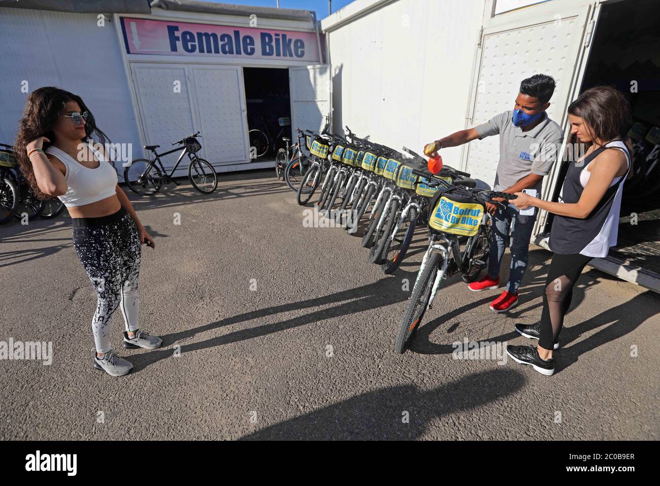 Beirut, Lebanon. 11th June, 2020. A woman rents a bike at a bike rental shop  in Beirut, Lebanon, June 11, 2020. It has become a common scene in Lebanon  recently that more