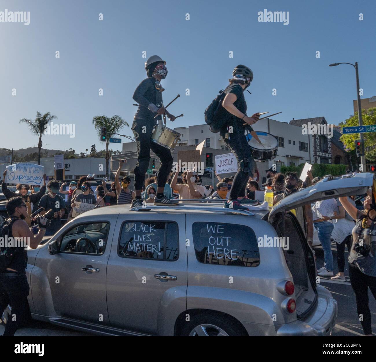 Black Lives matter protesters in Hollywood California ignore Covid19 social distancing as they play music, dance and should protest slogans. Stock Photo