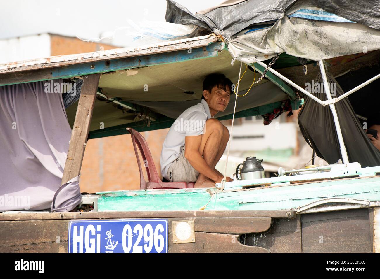 A man on his boat on the Hau River in Can Tho, Mekong Delta region ...
