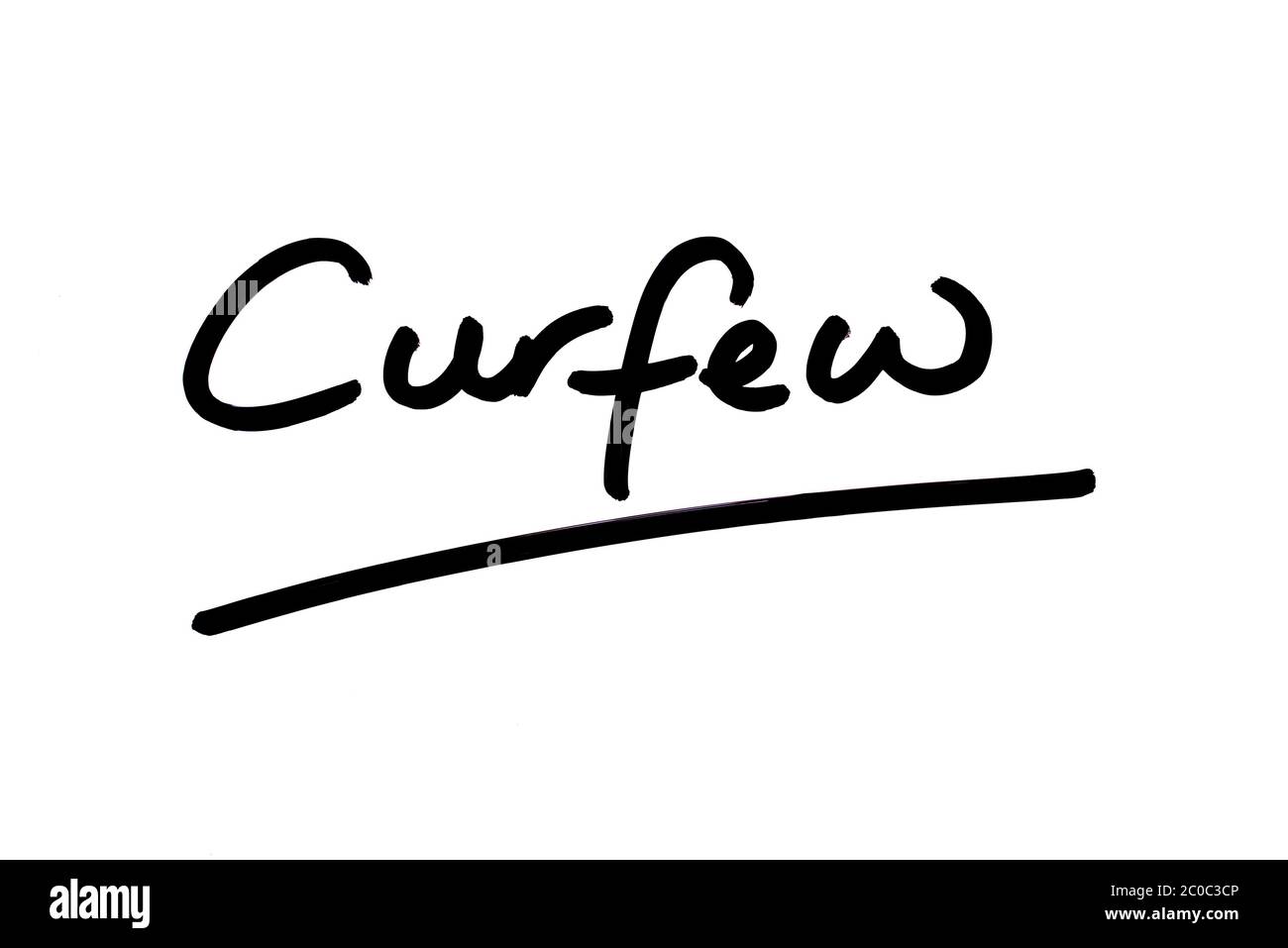 The word Curfew handwritten on a white background. Stock Photo