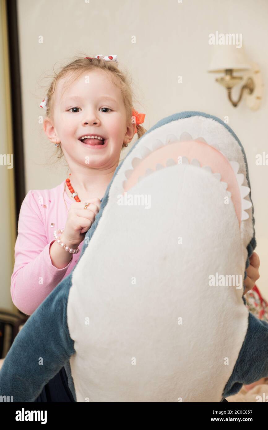 Girl Playing with Plush Toy Stock Photo - Alamy