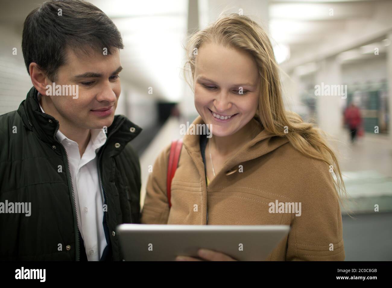 Young couple using tablet computer in underground Stock Photo