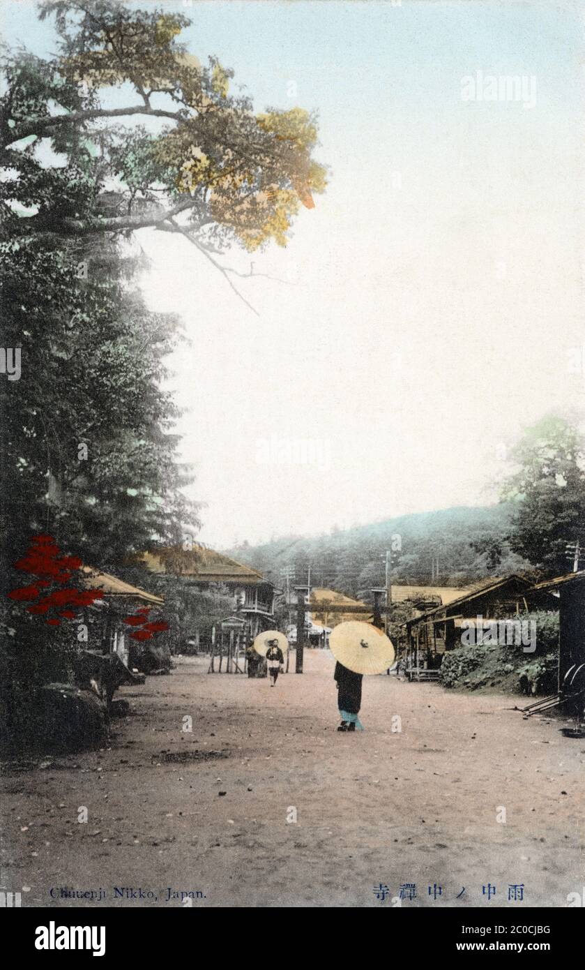[ 1900s Japan - Chuzenji in the Rain ] — People with paper parasols walk in the rain at Chuzenji in Nikko, Tochigi Prefecture.  20th century vintage postcard. Stock Photo