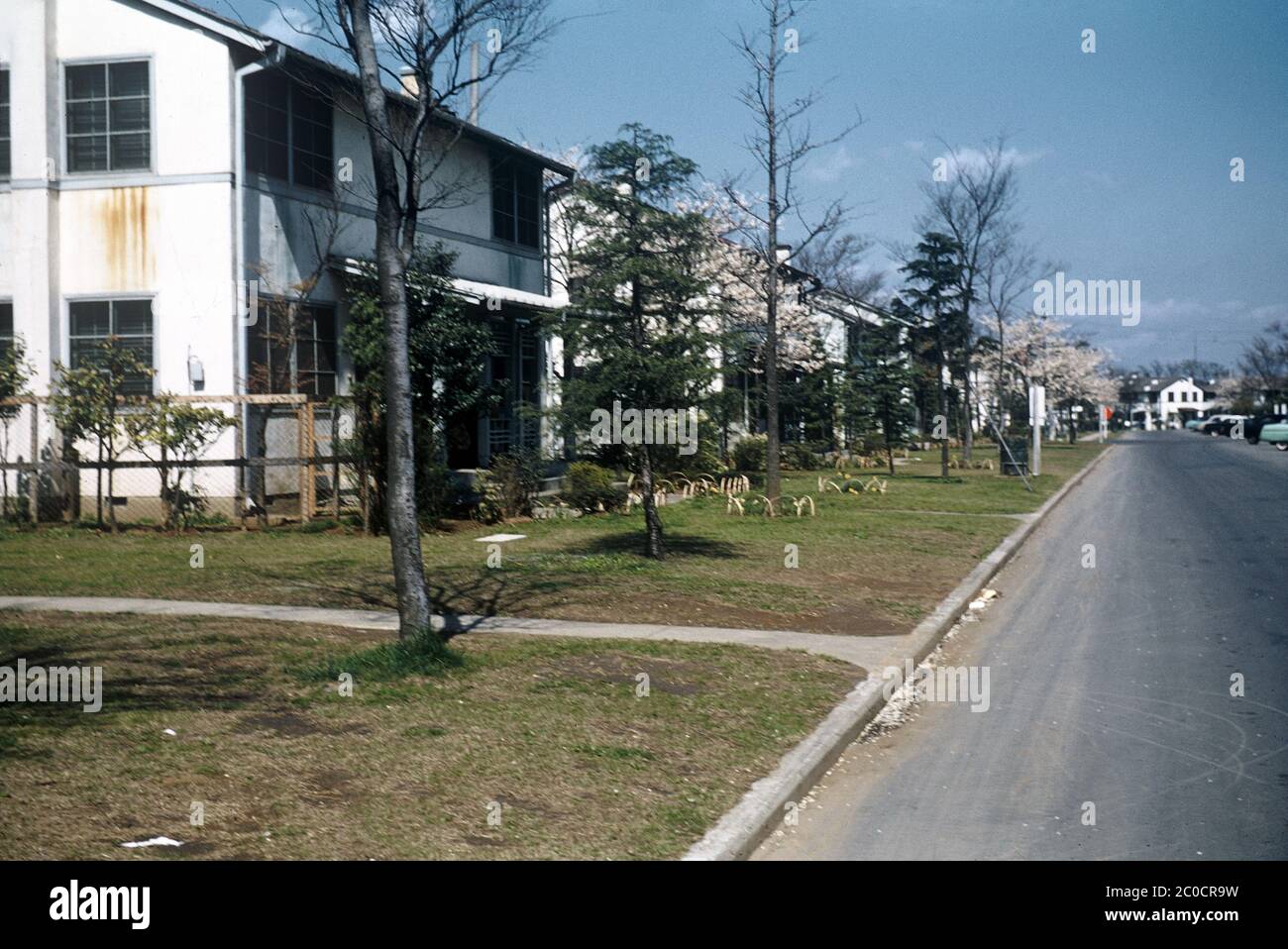 [ 1950s Japan - US Military Housing ] — US Military Housing in the Tokyo area, ca. 1950s.  According to a photo in the book Dependents Housing Japan & Korea, published in 1948 (Showa 23), the house on this image is a Duplex A-1a.  The design was used at Washington Heights, a United States Armed Forces housing complex located in Shibuya, Tokyo during the Allied occupation of Japan.  The complex was used as athlete housing during the 1964 Summer Olympics. After the Olympics, the area became Yoyogi Park.  20th century vintage slide film. Stock Photo