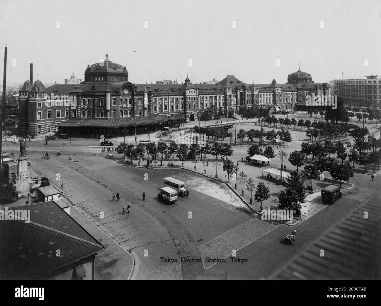 [ 1930s Japan - Tokyo Station ] — Tokyo Station, located in the Marunouchi business district of Tokyo, near the Imperial Palace grounds and the Ginza commercial district. Early 1930s.  The building was designed by architect Kingo Tatsuno (辰野金吾, 1854–1919) to celebrate Japan’s victory in the Russo-Japanese War. He patterned the domes, destroyed during the firebombings of 1945 (Showa 20), after Amsterdam’s central station.  The station was completed on December 18, 1914 (Taisho 3), and opened on the 20th.  20th century vintage gelatin silver print. Stock Photo