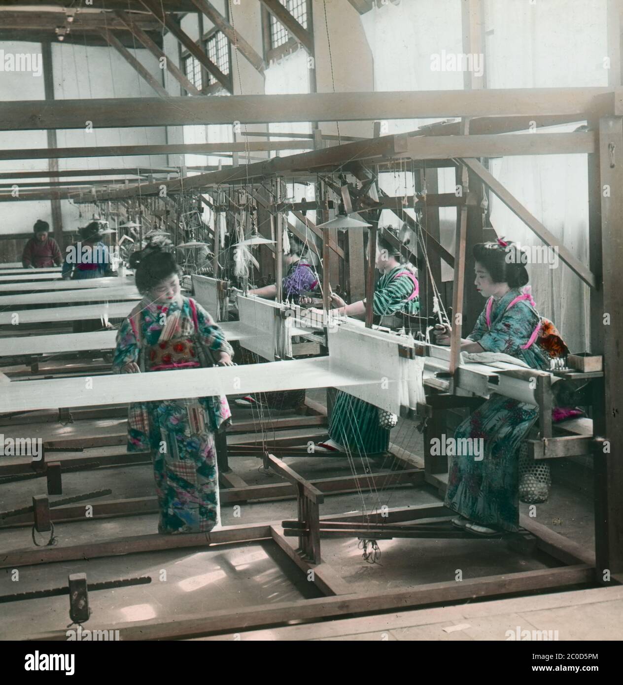 [ 1900s Japan - Japanese Silk Factory ] — Women in kimono weaving silk at a Japanese silk factory.  20th century vintage glass slide. Stock Photo