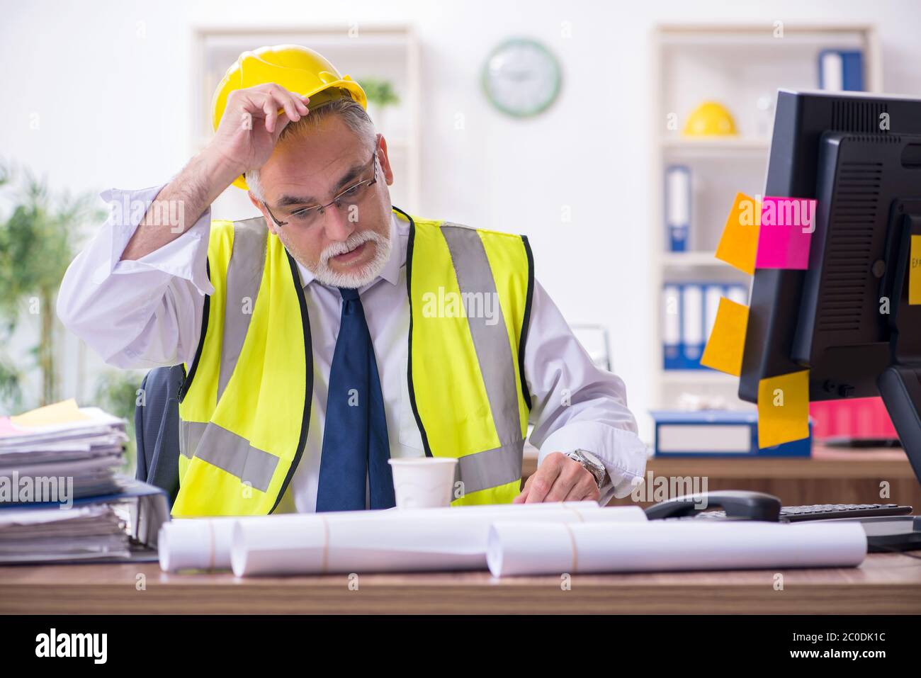 Old male architect working in office Stock Photo