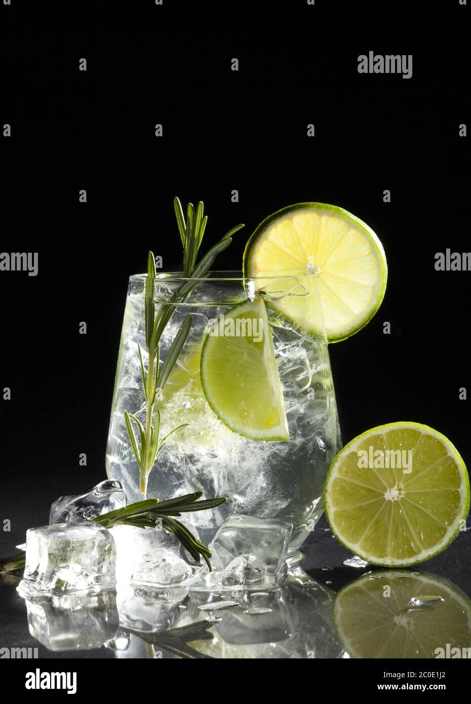 Gin and tonic cocktail with lime over black background. Stock Photo