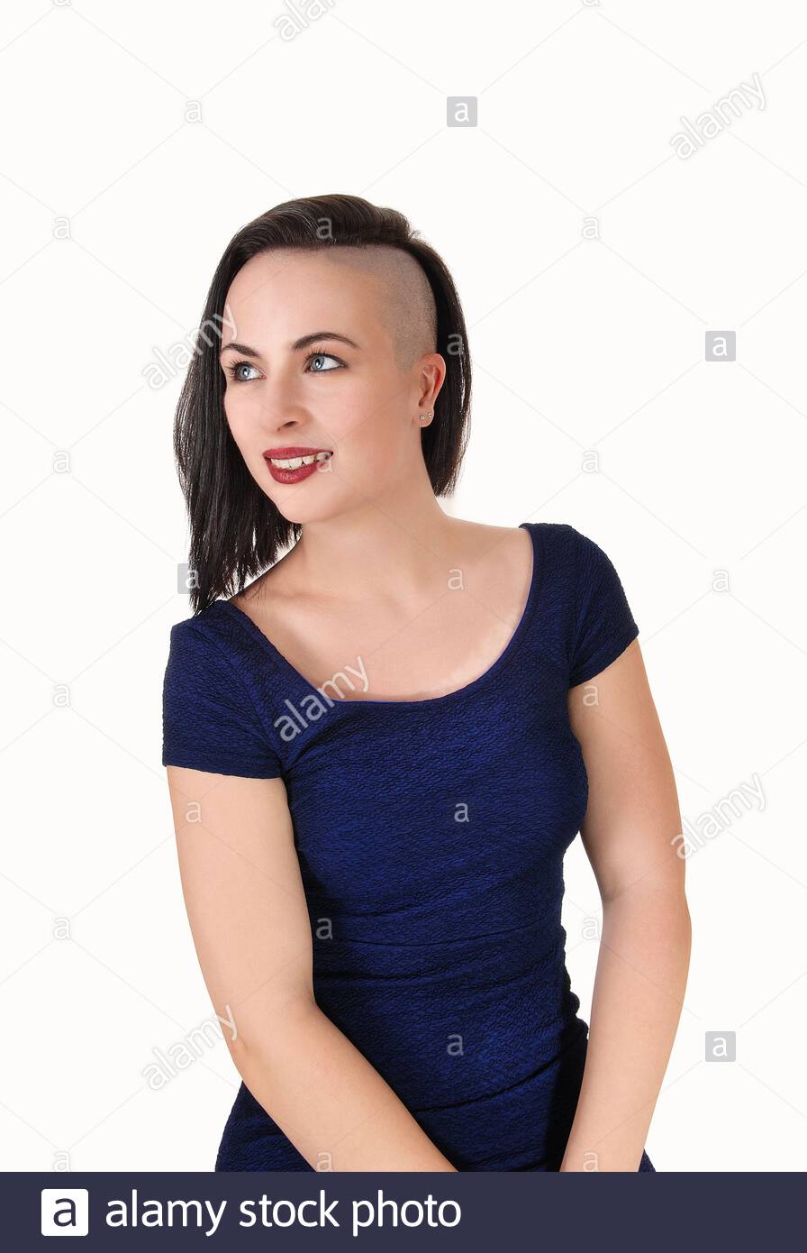 A Beautiful Young Woman In A Portrait Image With Short Black Hair Shaved On One Side Looking Away Isolated Over White Background Stock Photo Alamy