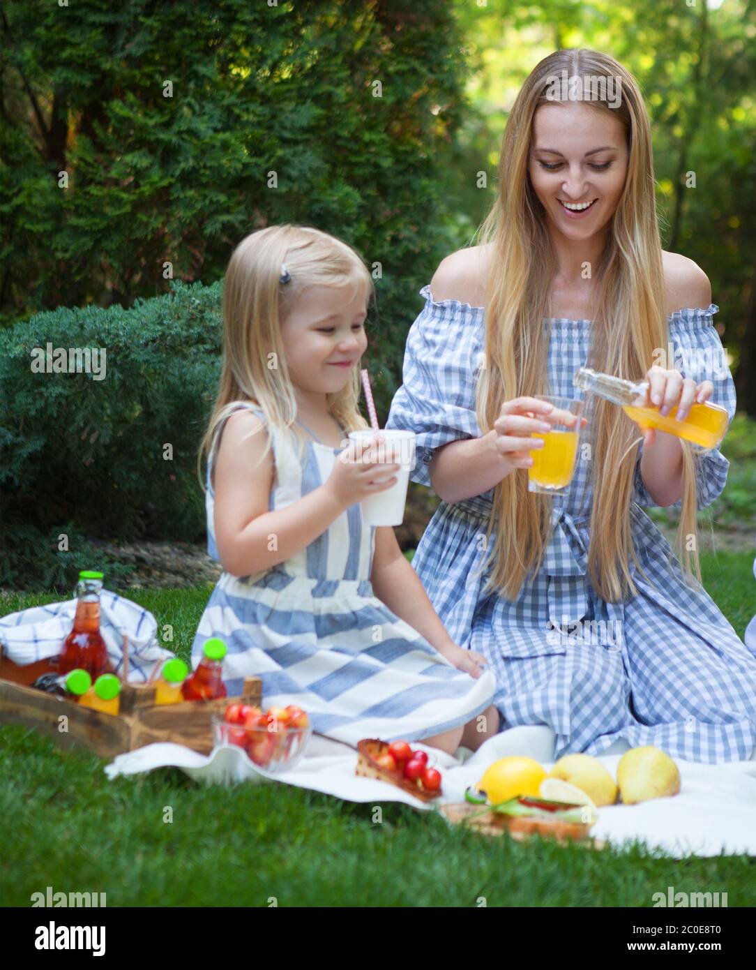 Happy young mother and daughter having picnic Stock Photo - Alamy