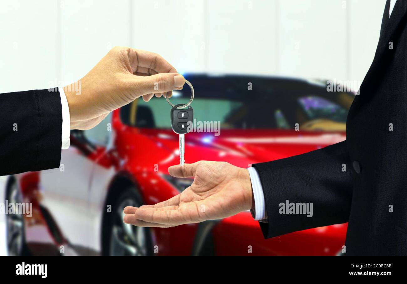 Car dealer and customer car key handover at agent showroom Stock Photo -  Alamy