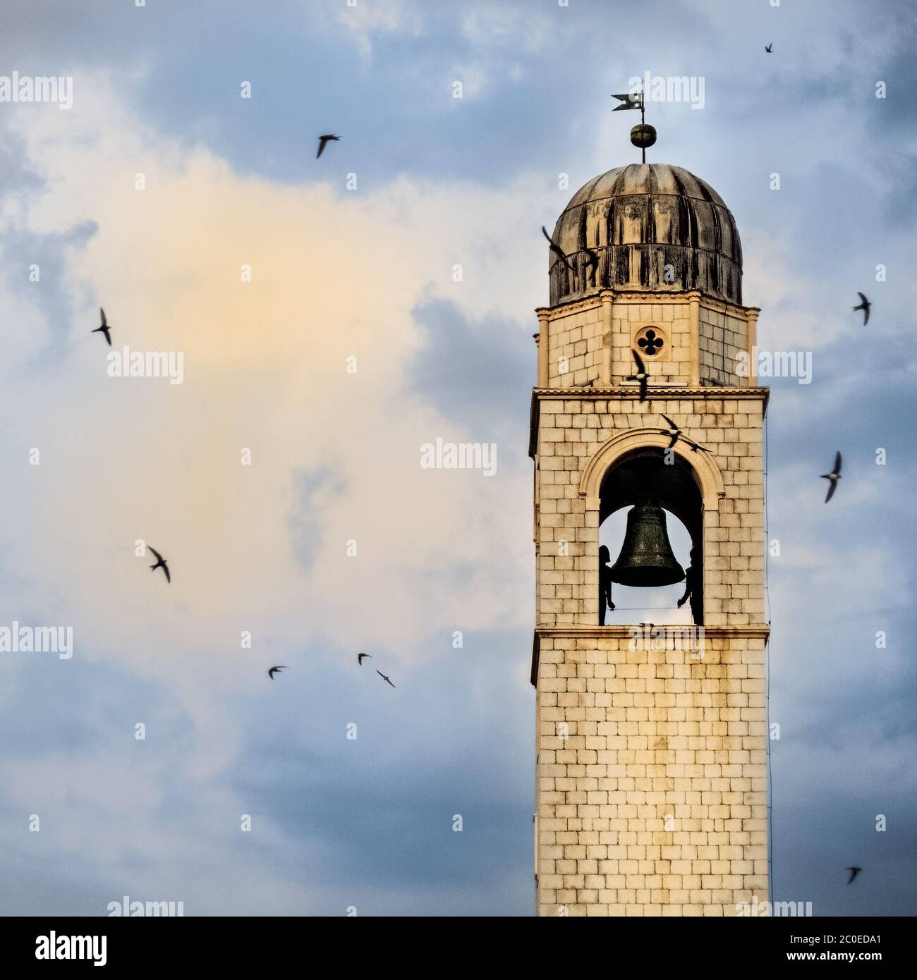 Swallows circling the clock tower in Dubrovnik Stock Photo