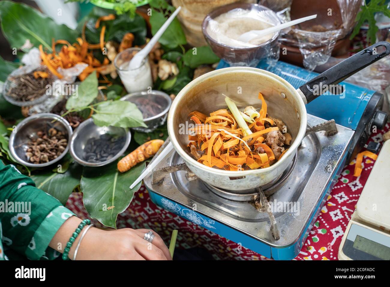 Traditional herbal drinks boiled with a pot and concoction of herbal medicine wedang uwuh Stock Photo