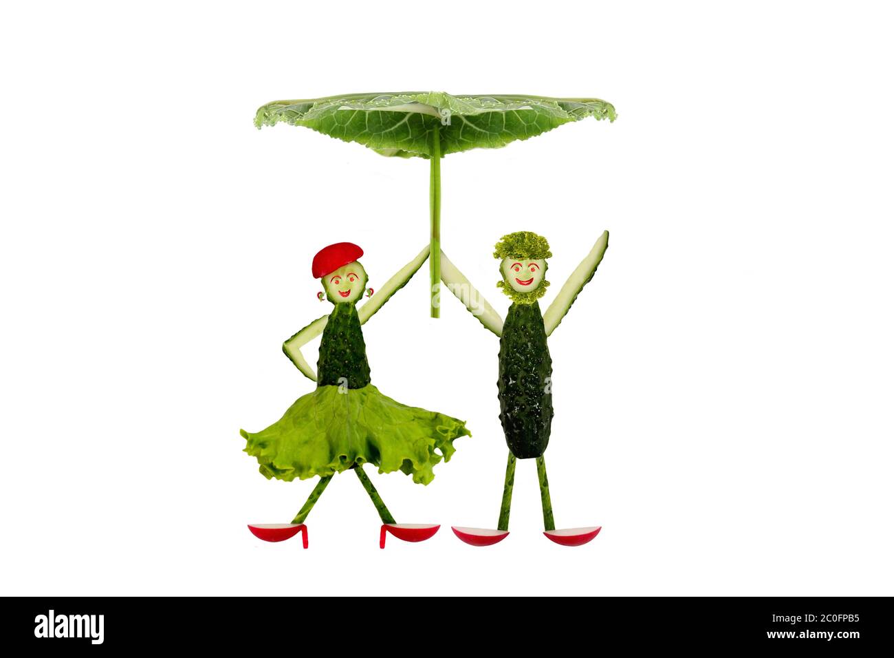 Funny little people made ??of cucumber under an umbrella Stock Photo