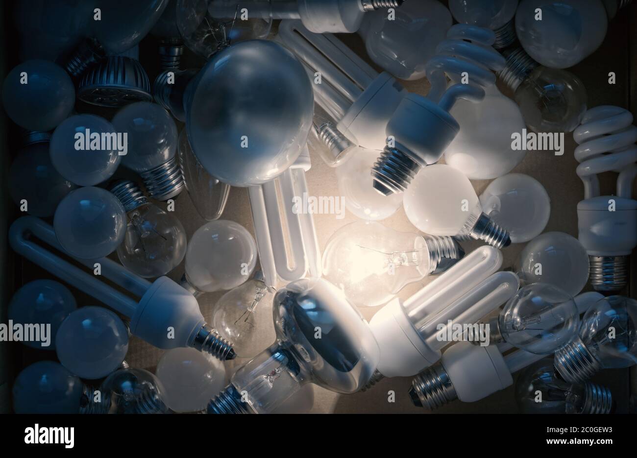 one light bulb on among others off Stock Photo