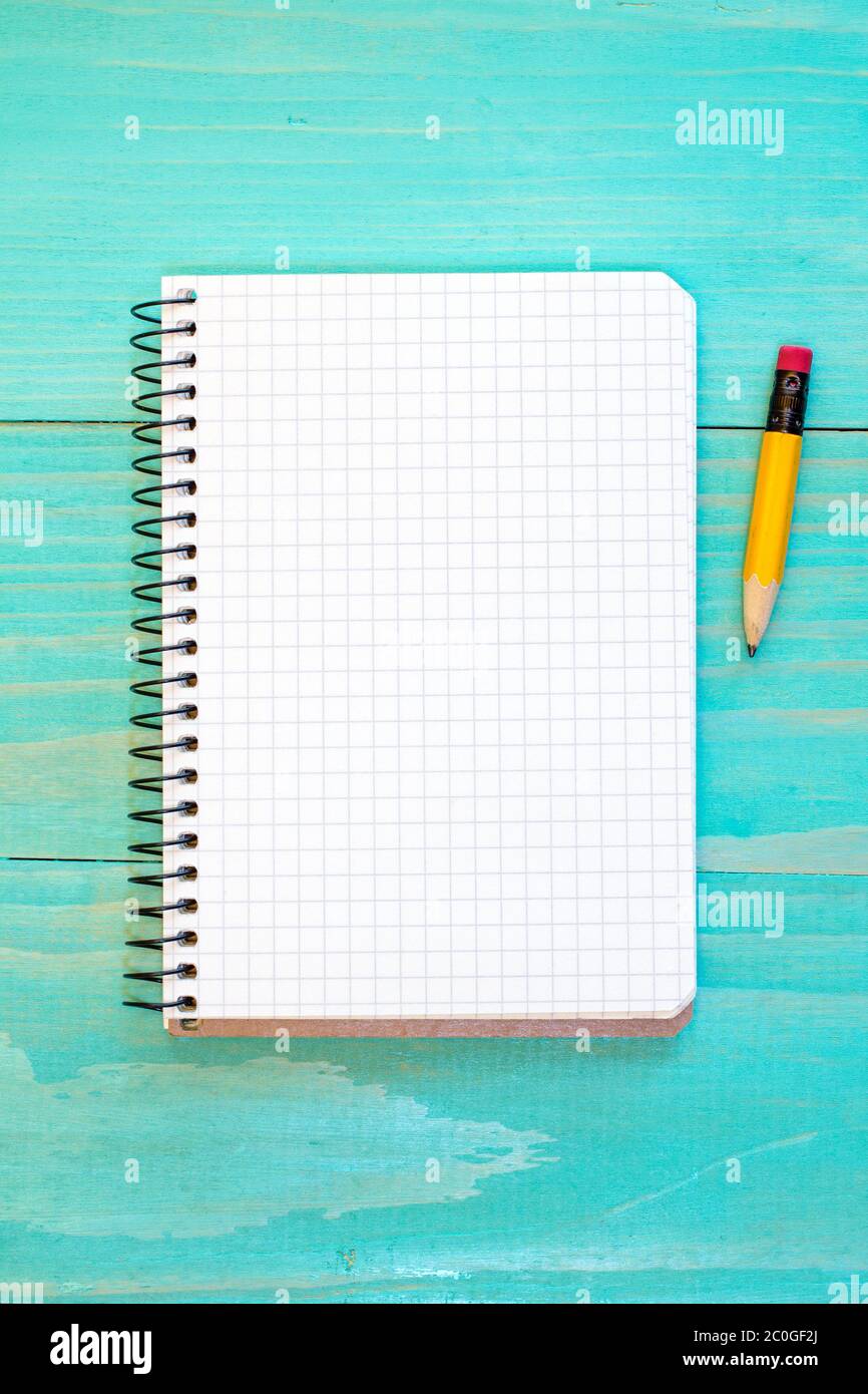 Notebook and pencil on the blue  surface Stock Photo
