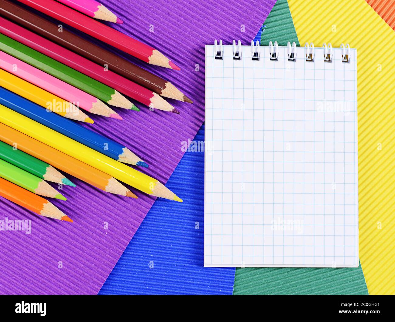 Color pencils on  paper with notebook Stock Photo
